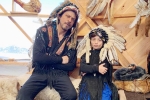 Shah Rukh Khan with Native American War Bonnet, shahrukh khan filmography, shah rukh khan and his son abram trolled for sporting native american war bonnets, Cultural appropriation