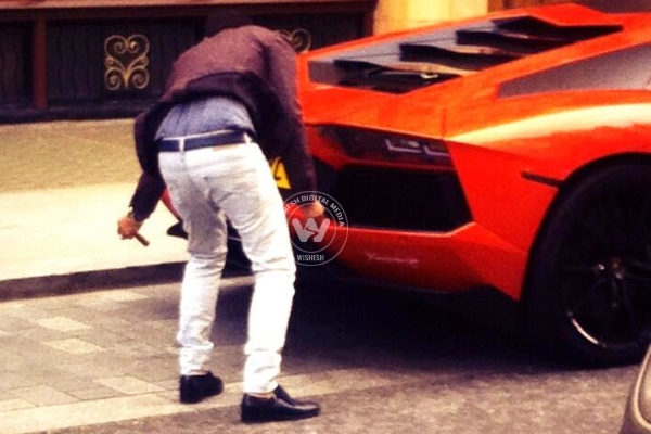 Man with supercar tries lighting cigar from exhaust},{Man with supercar tries lighting cigar from exhaust